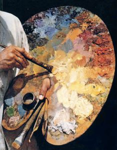 Close-up of an oil painting palette with mixed colors and brushes