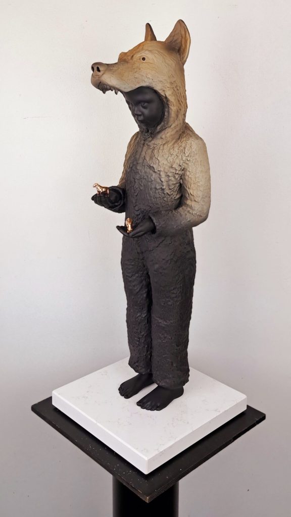 Hannes Verhoeven, "Balance 2.0," marble composite, 65 cm — child in a fox costume holding small gilded animal figurines