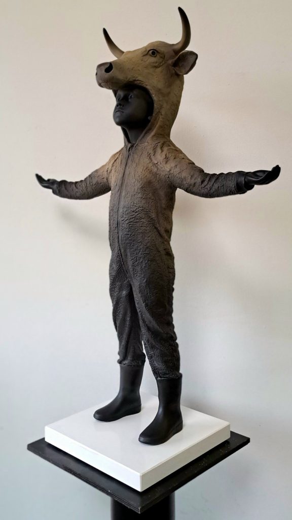 Hannes Verhoeven, "Here Comes the Rain," marble composite, 75 cm — child in a bull costume, arms spread wide
